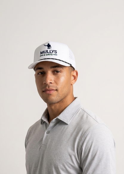 Man wearing a white cap with branding and a gray polo shirt on a light background